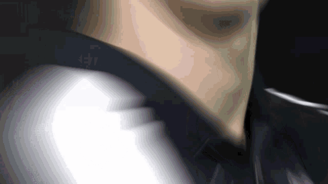 a blurred image of a person 's neck and shoulder