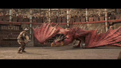 a man in a helmet stands in front of a red dragon