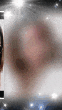 a blurry picture of a woman 's face with a light shining on her