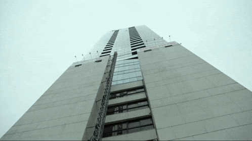 looking up at a tall building with a sign that says ' coca cola '