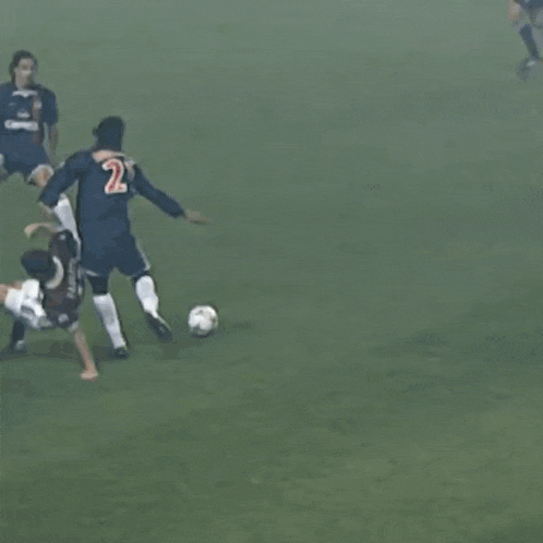 a group of soccer players with one wearing a jersey that says ' samsung ' on the front
