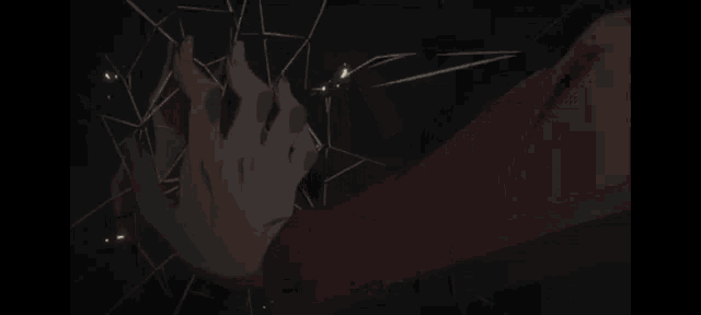 a close up of a person 's face in a dark room with a glowing light coming out of it .
