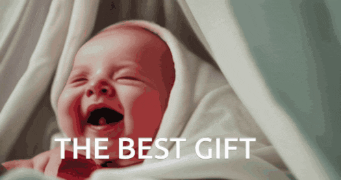 a baby is laughing under a blanket with the words the best gift above it