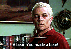 a man in a red shirt is holding a bow and arrow and says a bear you made a bear
