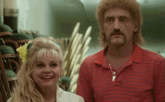 a man and a woman are standing next to each other in a room .