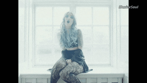 a woman with blue hair is sitting in front of a window and the words illustrate soul are on the bottom