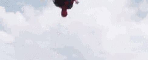 a man is holding a shield and jumping off a building .