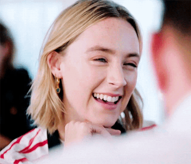 a close up of a woman 's face with a smile