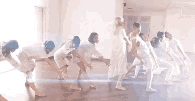 a group of people are dancing in a room