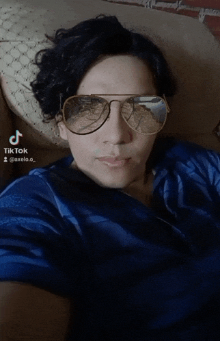 a man wearing sunglasses and a blue shirt has a tiktok account