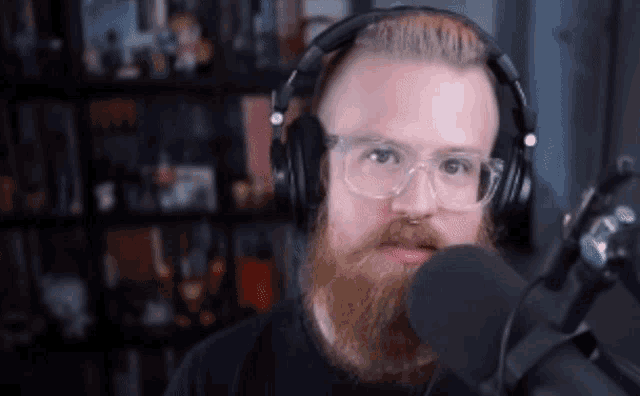 a man with a beard wearing headphones and glasses