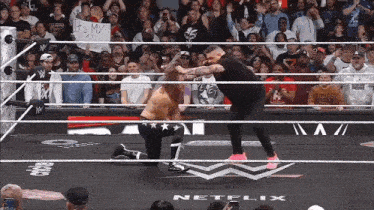 two wrestlers in a ring with a sign that says let 's my