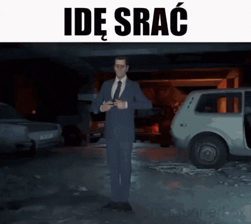 a man in a suit and tie is standing in front of a car in a parking garage .