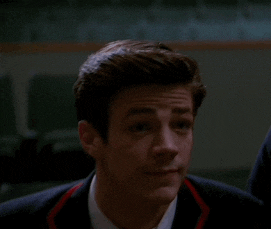 a close up of a man 's face with a suit and tie