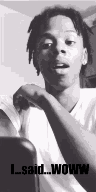 a black and white photo of a young man with the words " i said woww " on the bottom