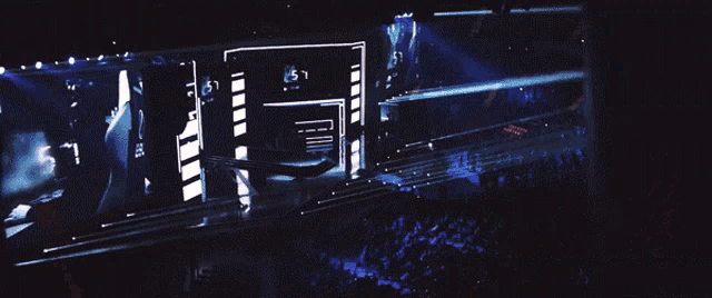 a crowd of people watching a concert with a large screen that says ' 1:51 ' on it