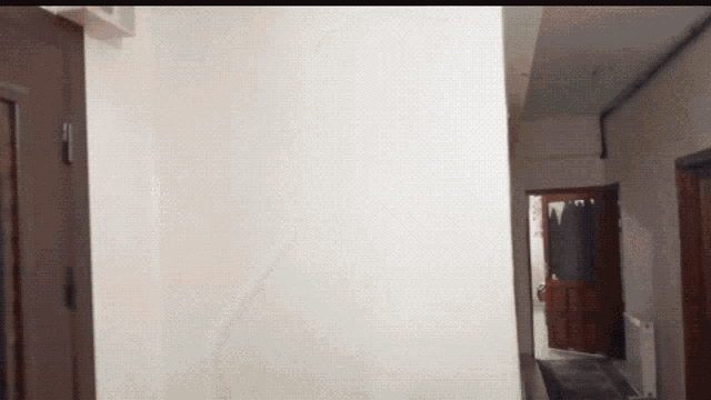a hallway with a door that is open