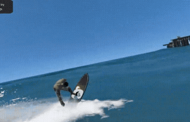 a man is riding a wave on a surfboard with the letter g on the front
