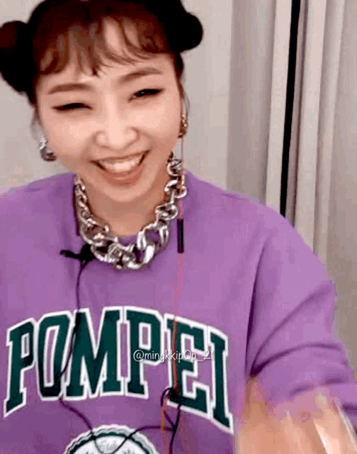 a woman is wearing a purple shirt that says pompei