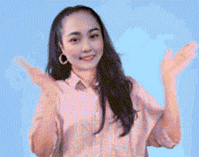 a pixelated image of a woman with her arms outstretched against a blue background