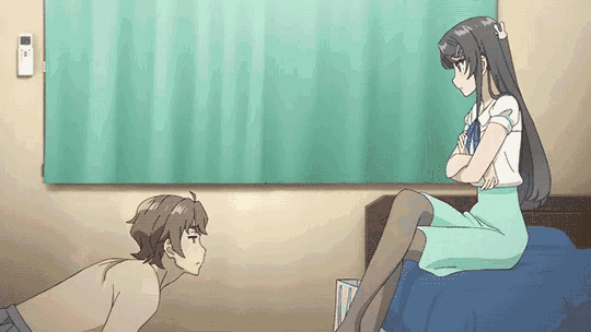a man is kneeling down in front of a woman who is sitting on a bed with her legs crossed