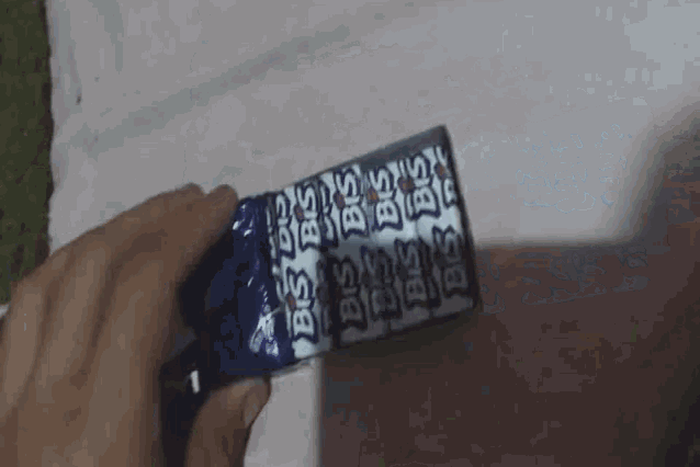 a close up of a person 's hand holding a piece of paper that has the number 1 on it