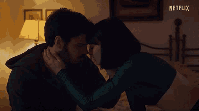 a man and a woman are kissing in a bedroom with a netflix logo in the corner