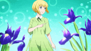 a girl in a green dress is pointing to purple flowers