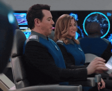 a man and a woman are sitting in blue uniforms