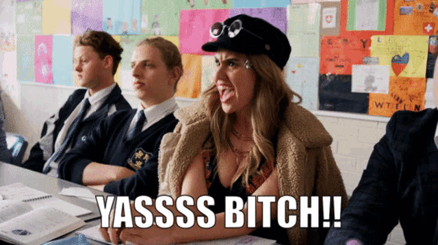 a woman sitting in a classroom with the words yasss bitch written on the bottom