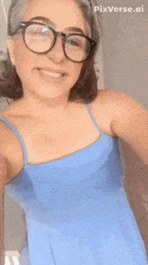 a woman wearing glasses and a blue dress is smiling with the words bat topissimo below her
