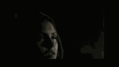 a close up of a man 's face in a dark room .