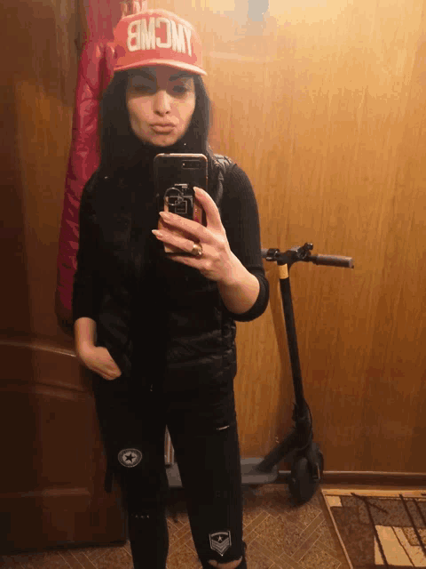 a woman taking a picture of herself with a hat that says jwcwb