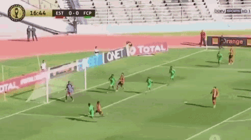 a soccer game is being played in a stadium with ads for total