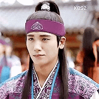 a young man wearing a purple headband and a purple and blue costume .