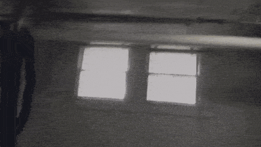 a pixelated image of a person standing in a dark room