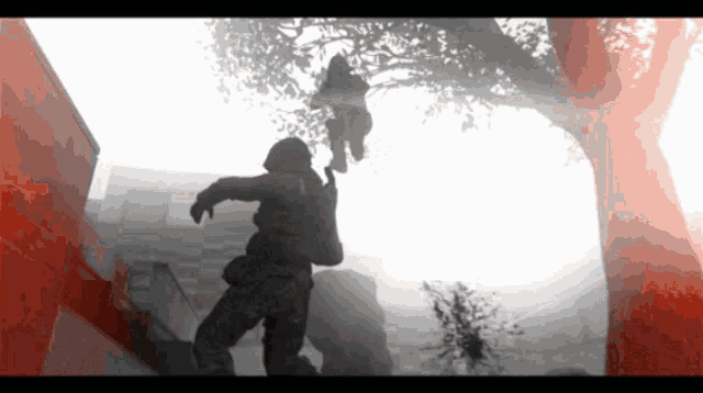a silhouette of a man holding another man 's hand in a video game