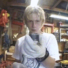 a man in a white shirt is holding a pair of shoes that say ' socks ' on them