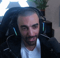 a man wearing headphones is sitting in a chair with a microphone