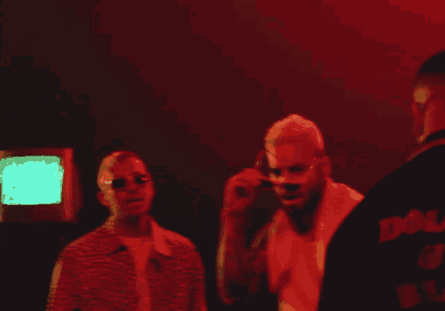 a man with a towel around his neck is dancing in a red light
