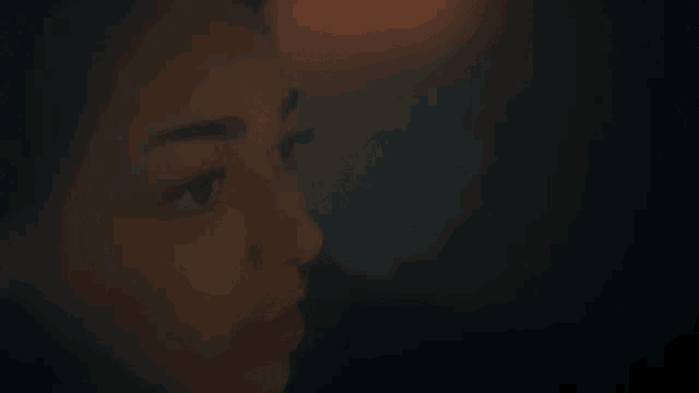 a close up of a woman 's face looking at something