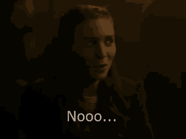 a woman in a dark room with the words nooo written on the bottom of her face .