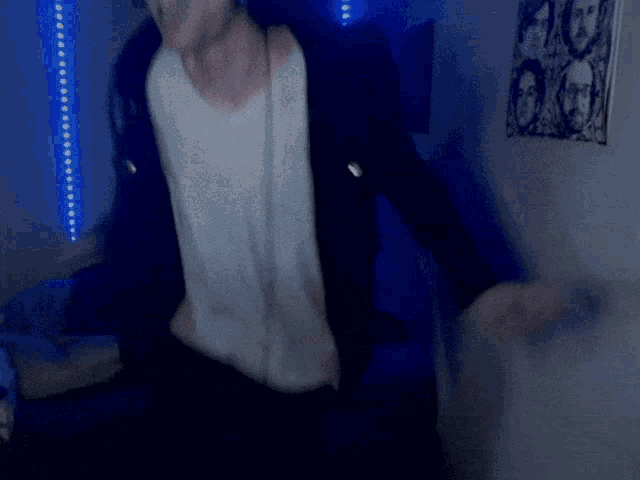 a man in a black jacket and white shirt dancing