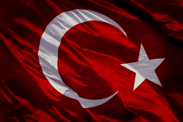 a red and white flag with a crescent moon and a white star