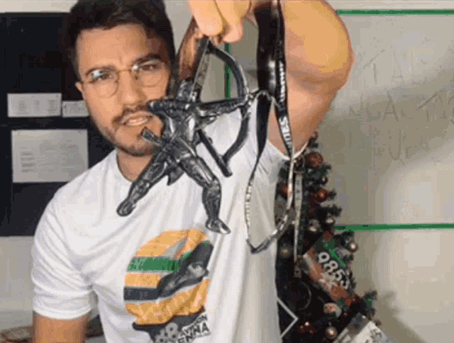 a man wearing a shirt that says senna is holding a toy