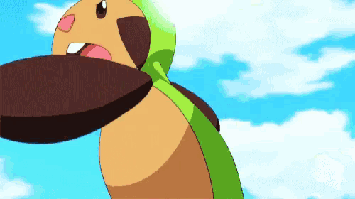 a cartoon character with a large mouth is holding something in its mouth .