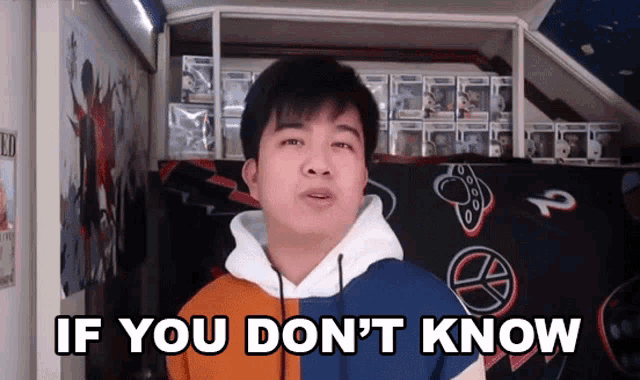 a man says if you don 't know in front of a display of funko pop figures