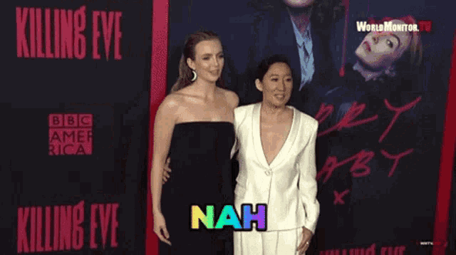two women are standing on a red carpet in front of a poster for killing eye