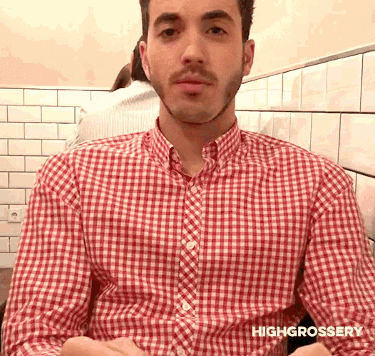 a man wearing a red and white checkered shirt says highgrossery on the bottom