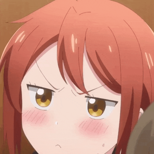 a close up of a girl with red hair making a face